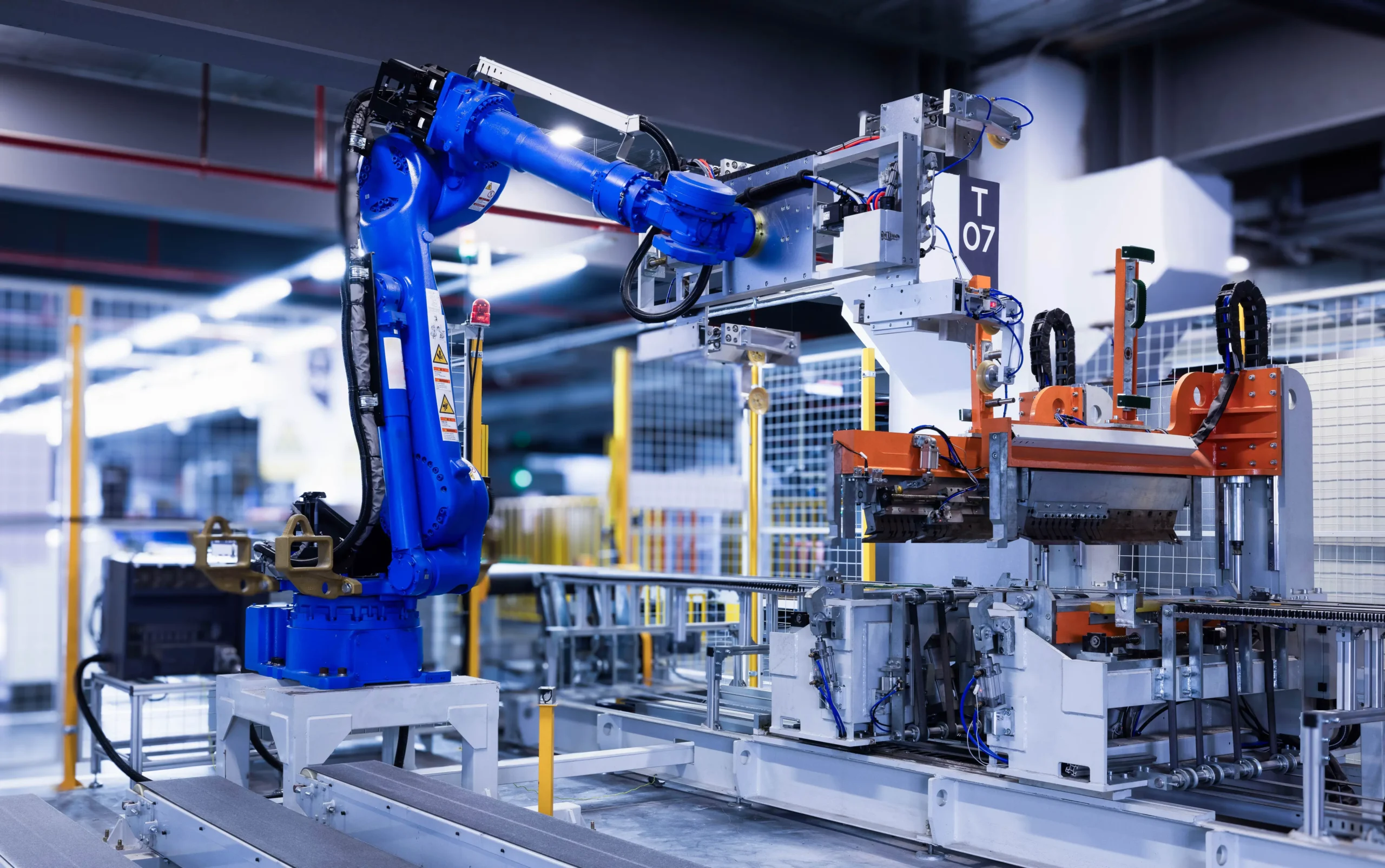 Blue industrial robotic arm in a factory